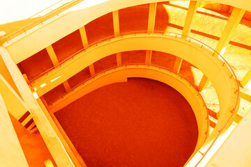 Open car parking garage with ramp on sunny day, above view. Toned in orange color