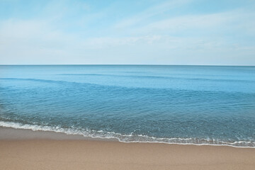 Beautiful view of sea shore under blue sky on sunny day