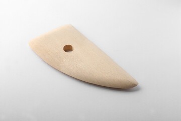 Wooden rib for clay modeling on white background