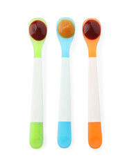 Healthy baby food in spoons on white background, top view
