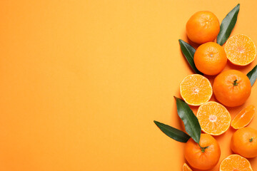 Flat lay composition with fresh ripe tangerines and space for text on orange background. Citrus fruit - obrazy, fototapety, plakaty