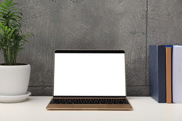 Workplace with modern laptop on white table. Mockup for design