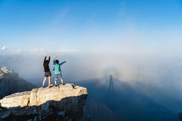 Female hikers standing on rock 