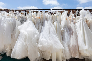 Clothing rack with hanging white wedding dresses