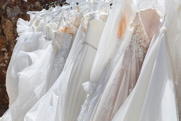 Rack with hanging white wedding dresses