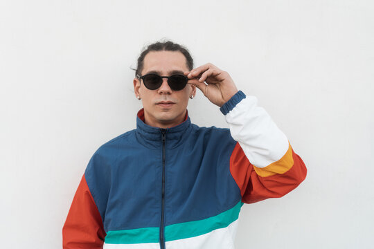 Man Wearing Colorful Track Suit And Sunglasses Portrait On White