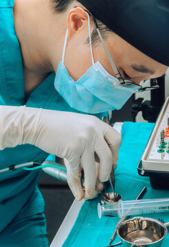 Dental Surgeon during surgery on teeth implants