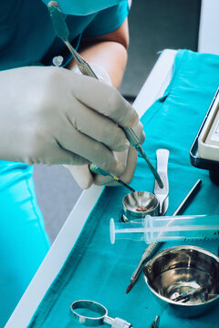 Dental Surgeon during surgery on teeth implants