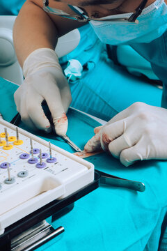 Dental Surgeon during surgery on teeth implants