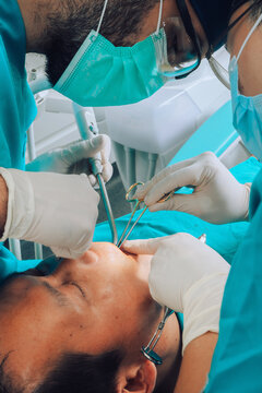 Putting implants during surgery in dental clinic