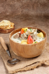 Soto Betawi. Traditional beef and offal soup from Betawi, Jakarta. The soup has been preplated in a bowl; ready to be served.