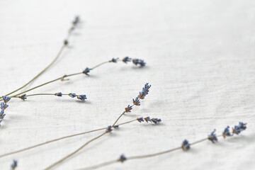 Lavender flowers laid on linen tablecloth.
