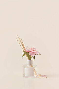 Glass aroma diffuser with stuck pink peony.