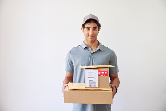 Hispanic delivery man with stack of parcels