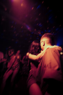 Anonymous couple crazy dancing at night party