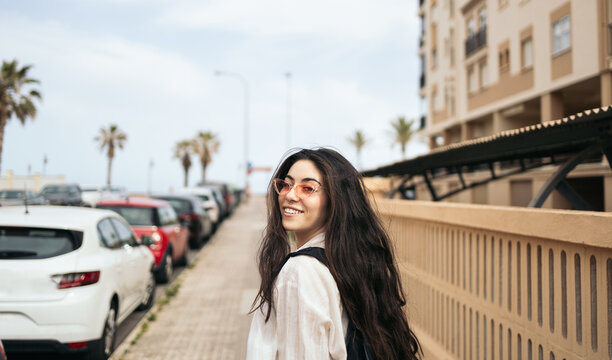 Stylish woman walking in a coastal area