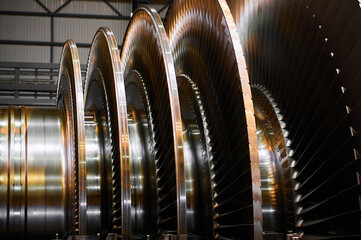 Golden rotor with blade rings of steam turbine in workshop © nordroden