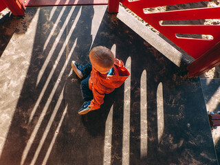 A child is playing on a playground with sand.