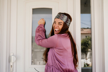 Happy woman knocking on door
