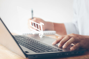 Business people use computer laptop for online shopping on a shopping cart virtual screens. And online payment option or digital wallet online transaction and e-commerce technology concept.