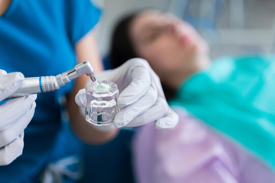 Dentist putting toothpaste on a metal instrument