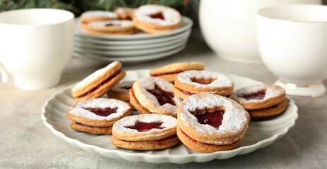 Plate with tasty Linzer cookies on table