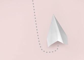 Paper plane on pink background