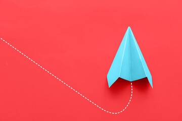 Paper plane on red background