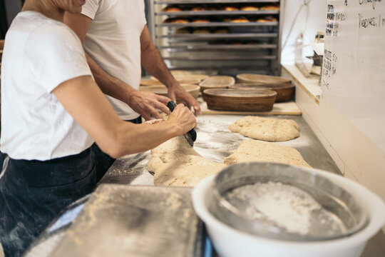 Bread Maker Working With Dough In Bakehouse