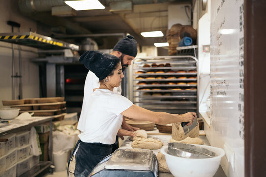 Co-workers at a bakery making artisan bread
