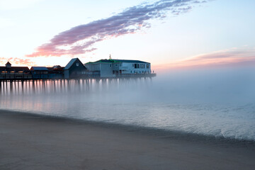 Pier in fog at dawn. A famous place on the coast of the Atlantic Ocean. Old pier. USA. Maine. Old...