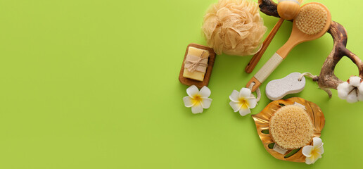 Set of bath supplies on green background with space for text