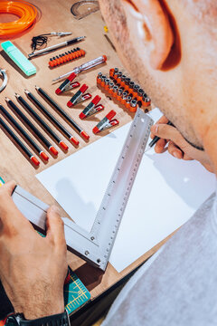 Detail of engineer hands drawing plans with ruler.