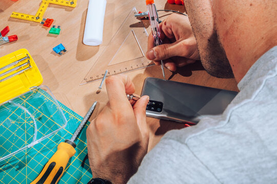 Technician repairing  device with his tools.