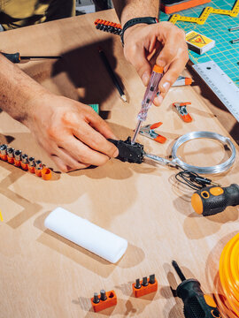 Technician working on wires and cables.