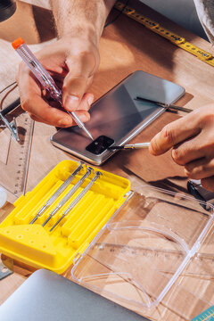 Technician repairing  device with his tools.