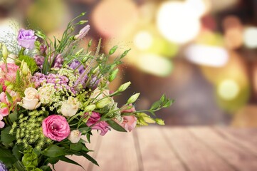 bouquet of fresh flowers on a wooden table. Neutral trendy colors interior decoration .