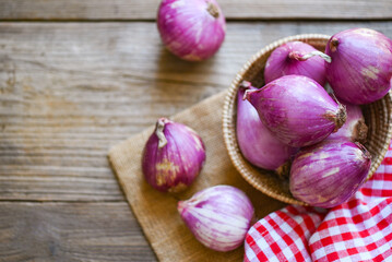 Shallots or red onion, purple shallots on wooden background , fresh shallot for medicinal products or herbs and spices Thai food made from this raw shallot