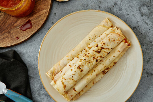 Crepes with jam on plate.