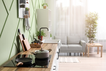 Obraz premium Interior of stylish kitchen with white counter and sofa