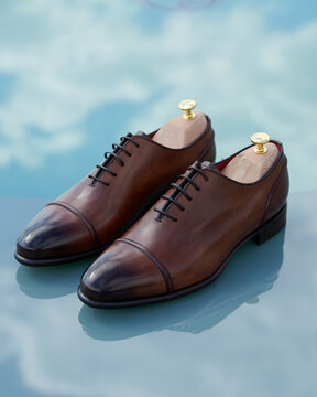 Beautiful leather men's shoes on a blue background