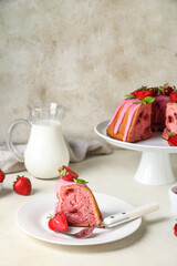 Plate with piece of strawberry cake on table