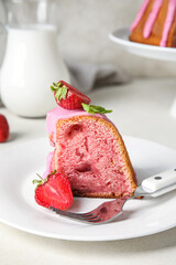 Plate with piece of strawberry cake on table, closeup