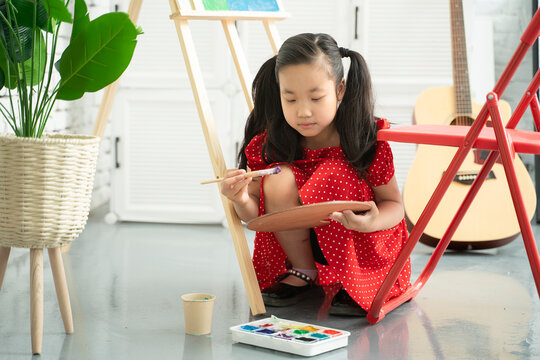 little girl is painting 