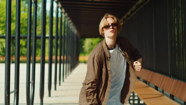 Young man dancing hip hop. Modern dance choreography. Male professional dancer, breakdancer showing dance movings outdoor. Musical video.