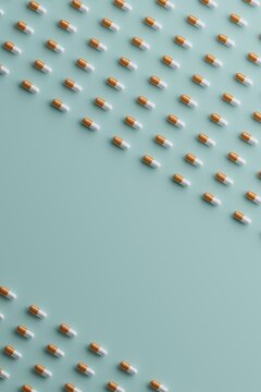 White and orange pills arranged in rows on a blue background.