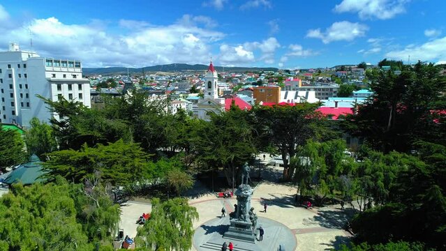 Aerial Forward Statue Of Portuguese Explorer In City Against Cloudy Sky - Punta Arenas, Chile