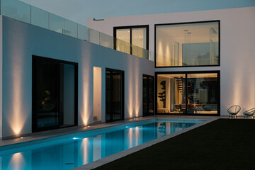 Luxury architecture with pool lighted at night