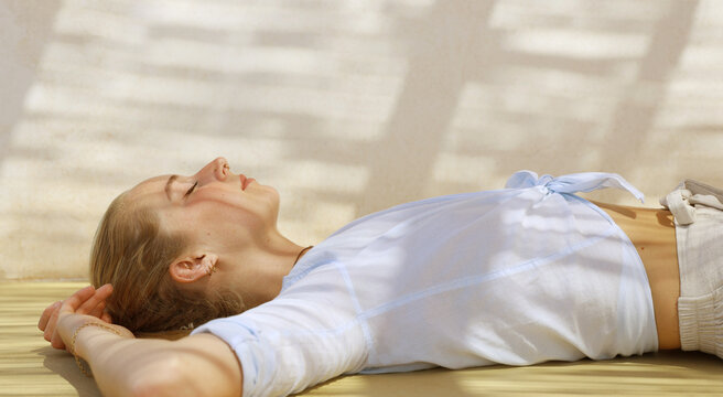 Young Woman In Blue Shirt Relaxing On Floor