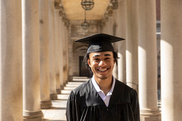 Medium Portrait of Young black college graduate with mortarboard 
